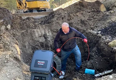 Randy performing a sewer lateral inspection in a vineyard